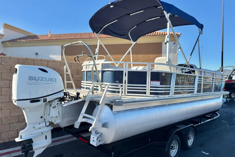Slide: The Image of 2023 Nepallo 22TL pontoon boat with Suzuki outboard motor, parked on trailer. - 6