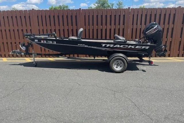 The Image of 2019 Tracker Panfish 16 boat on trailer, parked by wooden fence. - 0