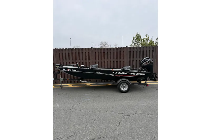 The Image of 2019 Tracker Panfish 16 boat on trailer, parked by wooden fence. - 1