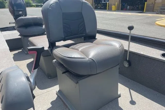 Slide: The Image of 2019 Tracker Panfish 16 boat interior with cushioned seating and steering controls. - 3