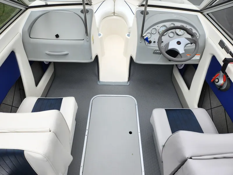 Slide: The Image of 2007 Bayliner Discovery 195 interior with steering wheel, seating, and dashboard controls. - 11