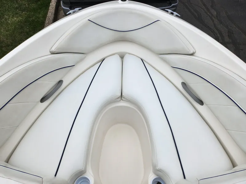 Slide: The Image of 2007 Bayliner Discovery 195 boat interior with white cushioned seating. - 16