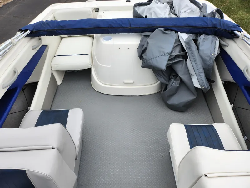 Slide: The Image of 2007 Bayliner Discovery 195 interior with seating and cover, showcasing spacious design. - 20