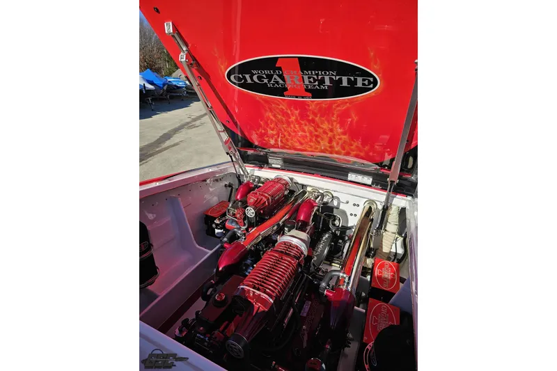 Slide: The Image of Engine compartment of a 2011 Cigarette 39' Top Gun Unlimited boat, showcasing powerful engines. - 100