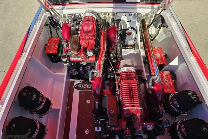 Slide: The Image of 2011 Cigarette 39' Top Gun Unlimited boat engine compartment with red high-performance engines. - 101