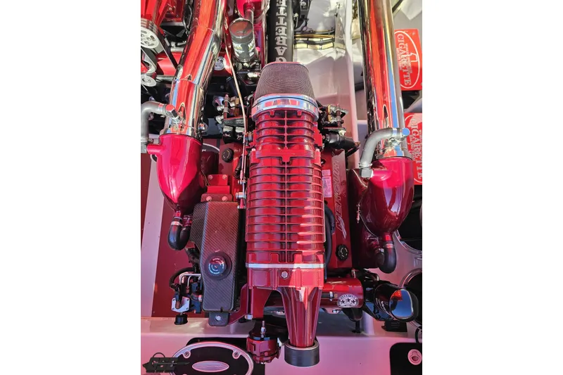 Slide: The Image of Engine of 2011 Cigarette 39' Top Gun Unlimited boat, featuring red and chrome components. - 103