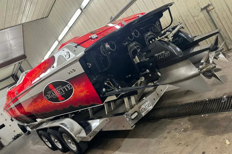 Slide: The Image of 2011 Cigarette 39' Top Gun Unlimited boat with sleek red design in outdoor setting. - 17