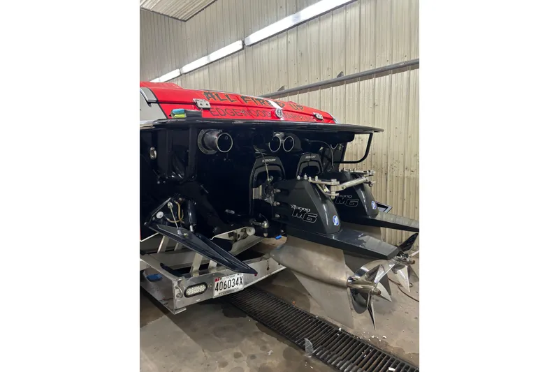 Slide: The Image of 2011 Cigarette 39' Top Gun Unlimited boat on trailer, red and black design. - 18