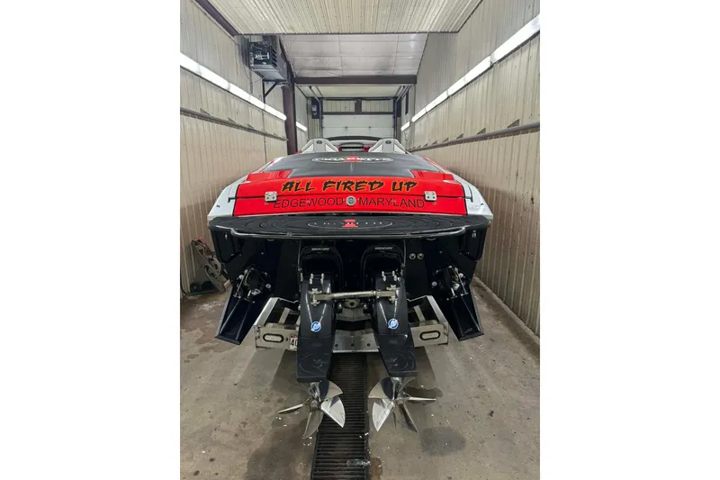 Slide: The Image of 2011 Cigarette 39' Top Gun Unlimited boat on trailer, red and black design. - 19