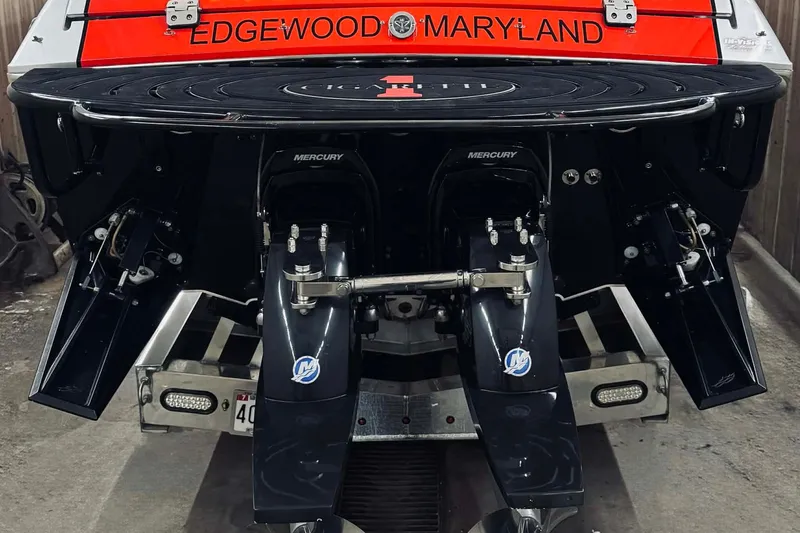 Slide: The Image of 2011 Cigarette 39' Top Gun Unlimited speedboat on trailer, vibrant red and black design. - 20