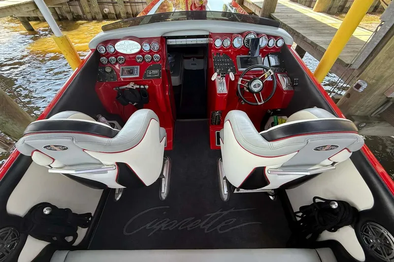 Slide: The Image of 2011 Cigarette 39' Top Gun Unlimited boat with red and black design on trailer. - 24