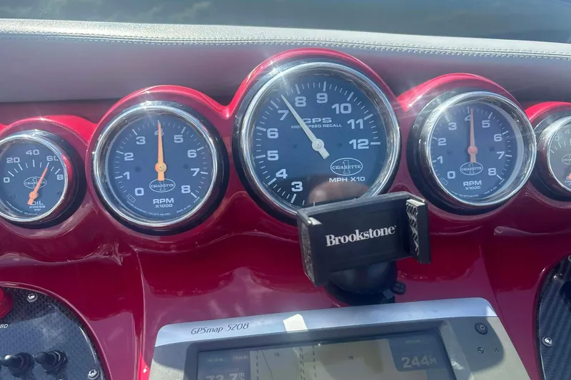 Slide: The Image of 2011 Cigarette 39' Top Gun Unlimited boat with visible engine components. - 30