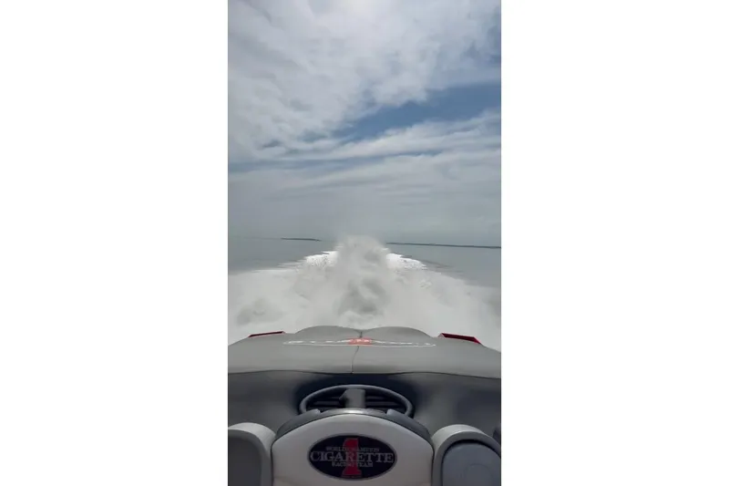 Slide: The Image of 2011 Cigarette 39' Top Gun Unlimited boat, red with black stripes, aerial view. - 40