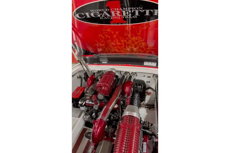 Slide: The Image of 2011 Cigarette 39' Top Gun Unlimited boat, red and black interior, World Champion Racing Team logo. - 43