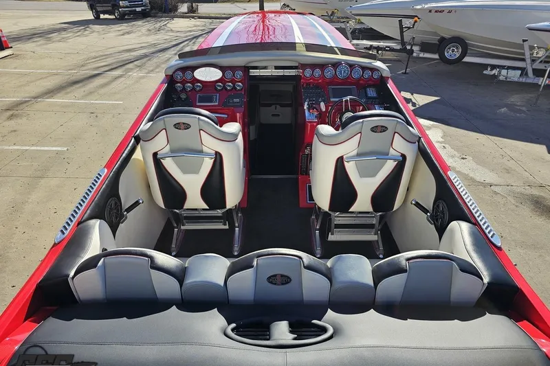 Slide: The Image of 2011 Cigarette 39' Top Gun Unlimited boat interior with red and white seating and dashboard. - 48