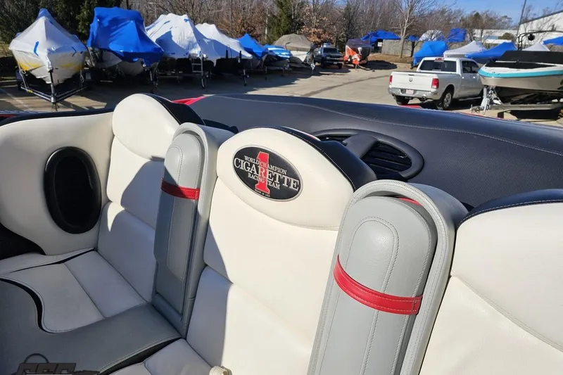 Slide: The Image of 2011 Cigarette 39' Top Gun Unlimited boat interior with branded seating in a marina. - 53