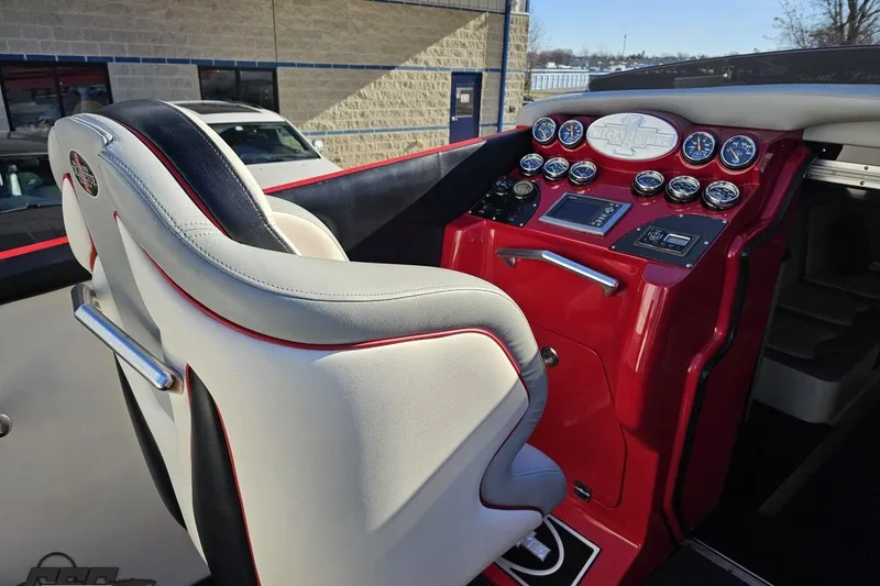 Slide: The Image of 2011 Cigarette 39' Top Gun Unlimited boat cockpit with red dashboard and white seat. - 57