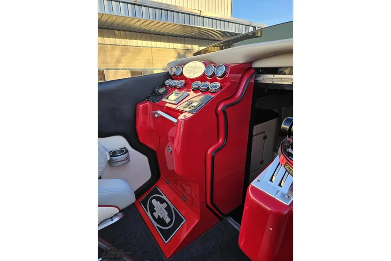 Slide: The Image of 2011 Cigarette 39' Top Gun Unlimited boat dashboard with red accents and multiple gauges. - 58