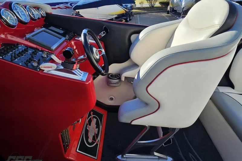 Slide: The Image of Interior of 2011 Cigarette 39' Top Gun Unlimited boat with red dashboard and white seats. - 64