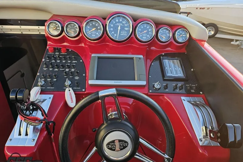 Slide: The Image of 2011 Cigarette 39' Top Gun Unlimited dashboard with gauges, steering wheel, and controls. - 68