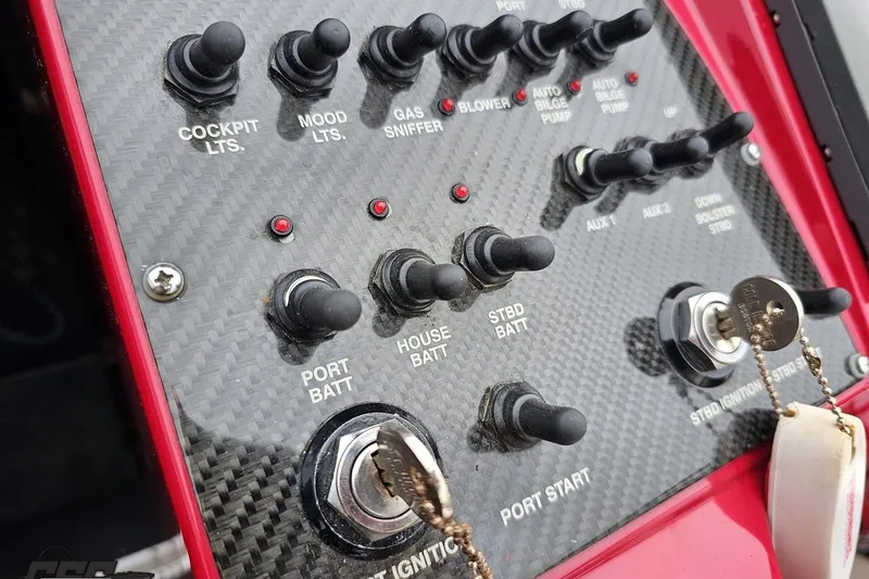 Slide: The Image of Control panel of a 2011 Cigarette 39' Top Gun Unlimited boat with switches and ignition keys. - 71