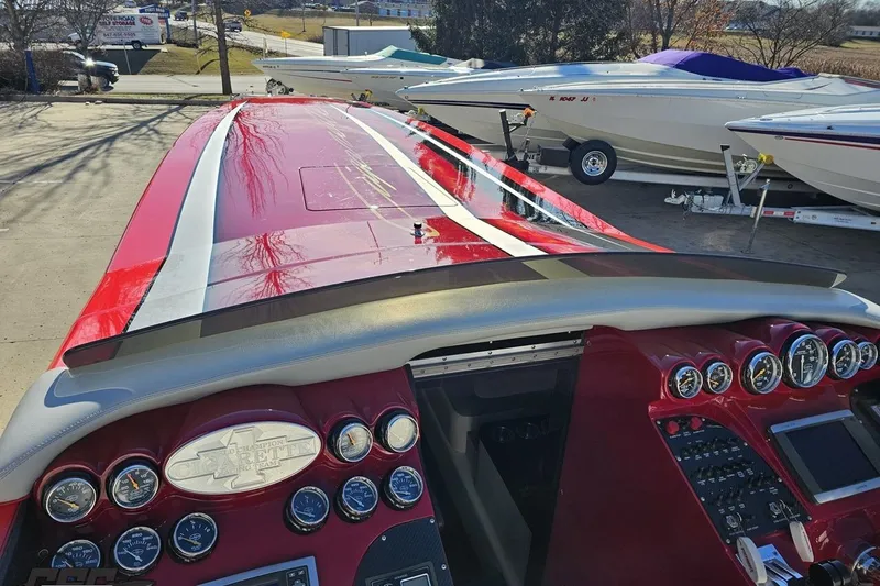 Slide: The Image of 2011 Cigarette 39' Top Gun Unlimited boat with red and white design, detailed dashboard. - 72