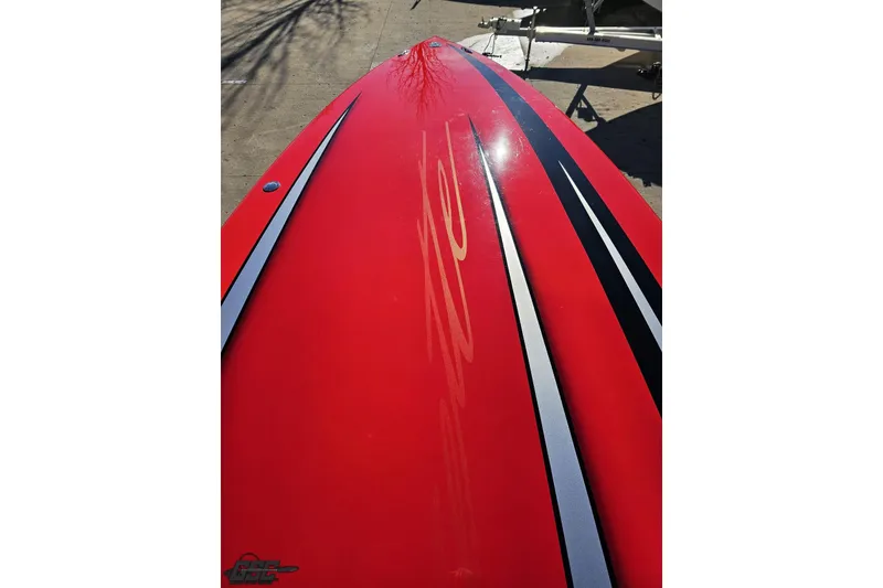 Slide: The Image of Red 2011 Cigarette 39' Top Gun Unlimited boat with sleek black and white stripes. - 74