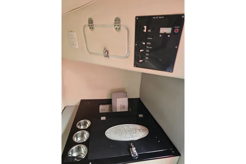 Slide: The Image of Interior of 2011 Cigarette 39' Top Gun Unlimited boat with control panel and storage. - 84