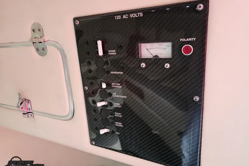 Slide: The Image of Control panel of a 2011 Cigarette 39' Top Gun Unlimited boat, featuring AC voltage settings. - 85