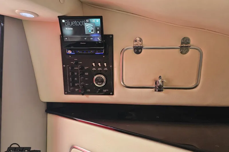 Slide: The Image of Control panel and Bluetooth stereo in 2011 Cigarette 39' Top Gun Unlimited boat interior. - 86