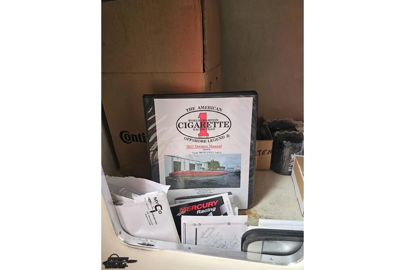 Slide: The Image of 2011 Cigarette 39' Top Gun Unlimited owner's manual in storage compartment. - 87