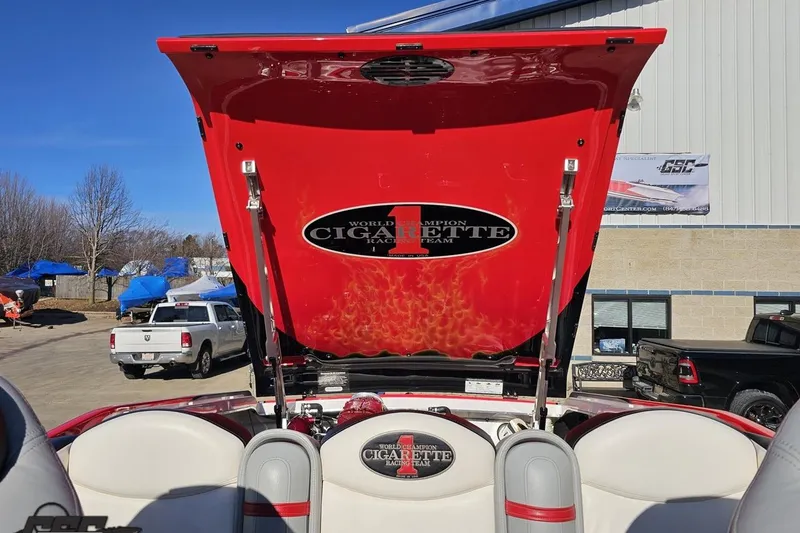 Slide: The Image of 2011 Cigarette 39' Top Gun Unlimited boat with open engine hatch, outdoor setting. - 99