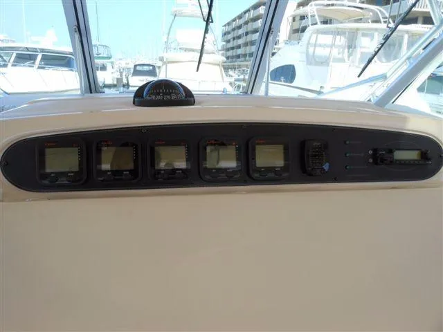Slide: The Image of Dashboard of a 2007 Grady-White Express 360 boat in a marina. - 12