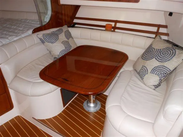 Slide: The Image of 2007 Grady-White Express 360 cabin interior with seating and table. - 17