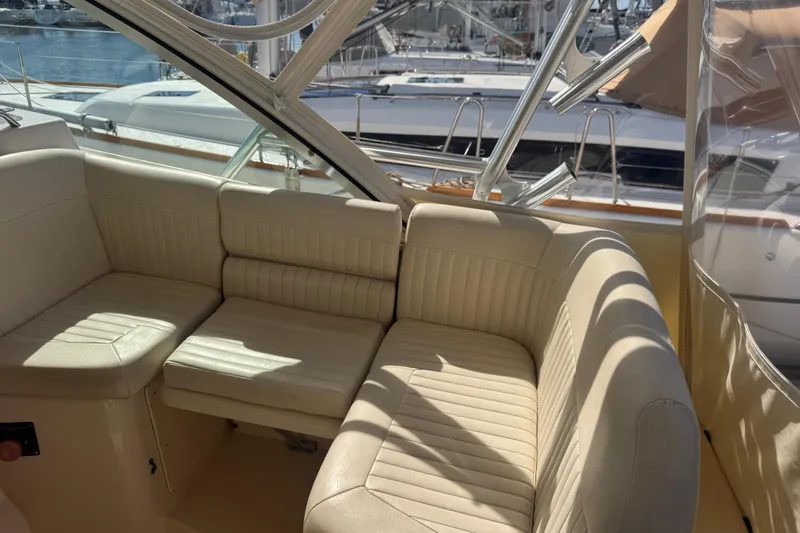 Slide: The Image of 2007 Grady-White Express 360 boat interior with beige seating and marina view. - 34