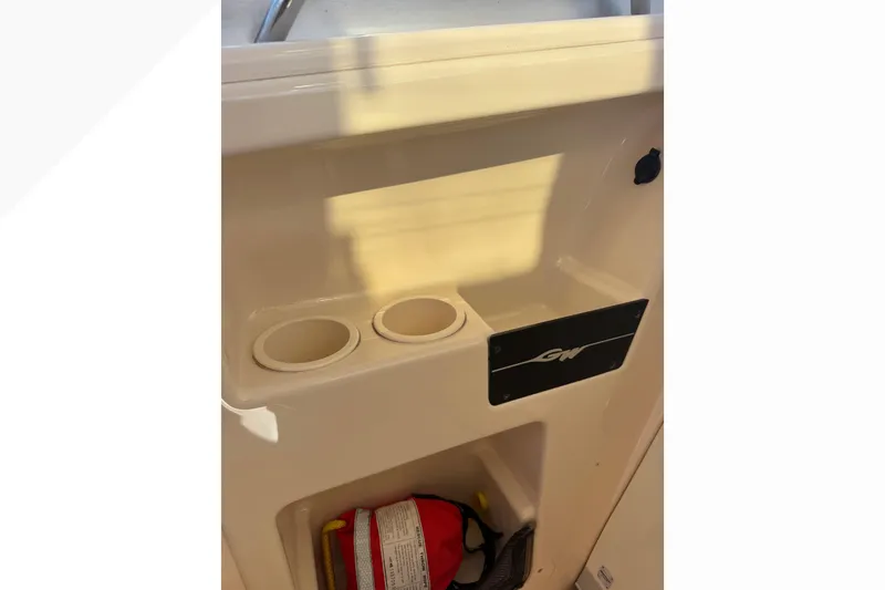 Slide: The Image of 2007 Grady-White Express 360 boat interior with cup holders and storage compartment. - 45