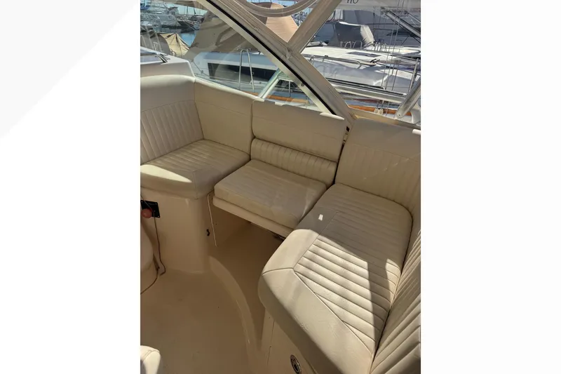 Slide: The Image of 2007 Grady-White Express 360 boat interior with beige seating and marina view. - 52
