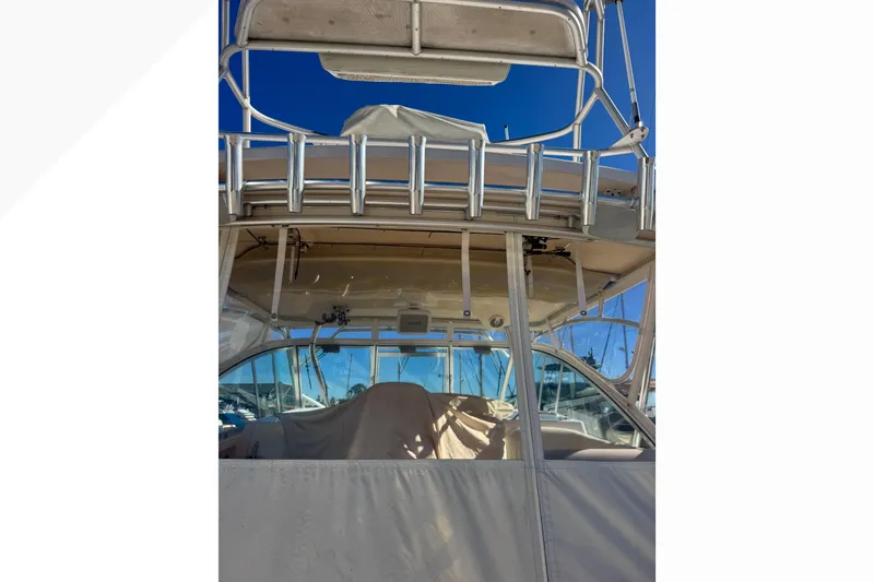 Slide: The Image of 2007 Grady-White Express 360 boat, covered and docked, with clear blue sky background. - 55