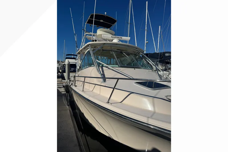 Slide: The Image of 2007 Grady-White Express 360 boat docked at marina, clear blue sky background. - 57