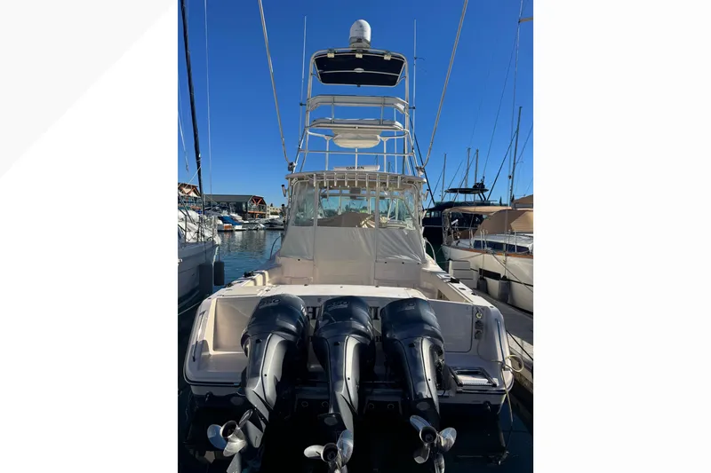 Slide: The Image of 2007 Grady-White Express 360 boat with triple outboard engines docked at marina. - 59