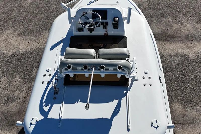 Slide: The Image of 2020 Sportsman Masters 267OE Bay Boat with powerful outboard motor, parked outdoors. - 12