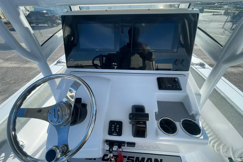Slide: The Image of 2020 Sportsman Masters 267OE Bay Boat interior view with T-top and electronics. - 16