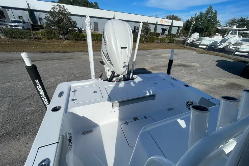 Slide: The Image of 2020 Sportsman Masters 267OE Bay Boat with cushioned seating, parked outdoors. - 19