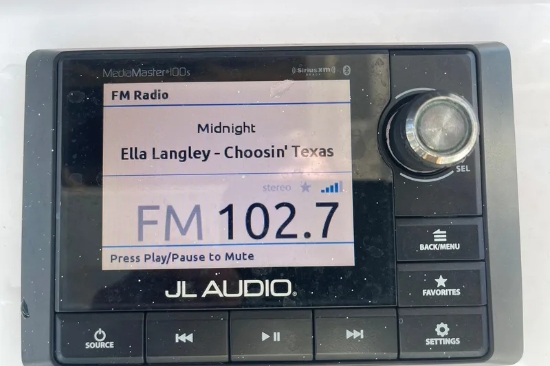 Slide: The Image of 2020 Sportsman Masters 267OE Bay Boat on trailer, parked outdoors under clear sky. - 26