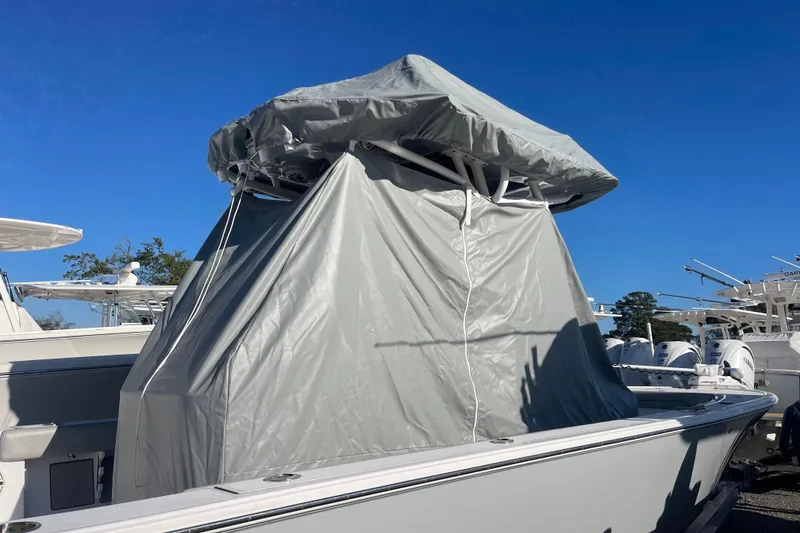Slide: The Image of 2020 Sportsman Masters 267OE Bay Boat in storage, covered engine, clear blue sky. - 29
