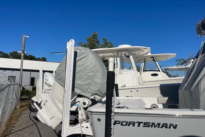 Slide: The Image of 2020 Sportsman Masters 267OE Bay Boat with cover, displayed outdoors. - 30