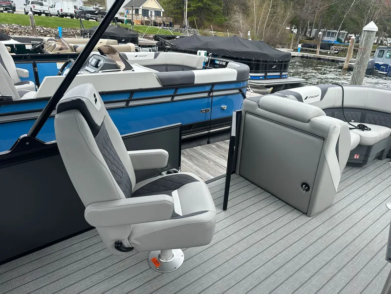 Slide: The Image of 2026 Starcraft SLS 3 R pontoon boat with luxurious seating at the dock. - 12