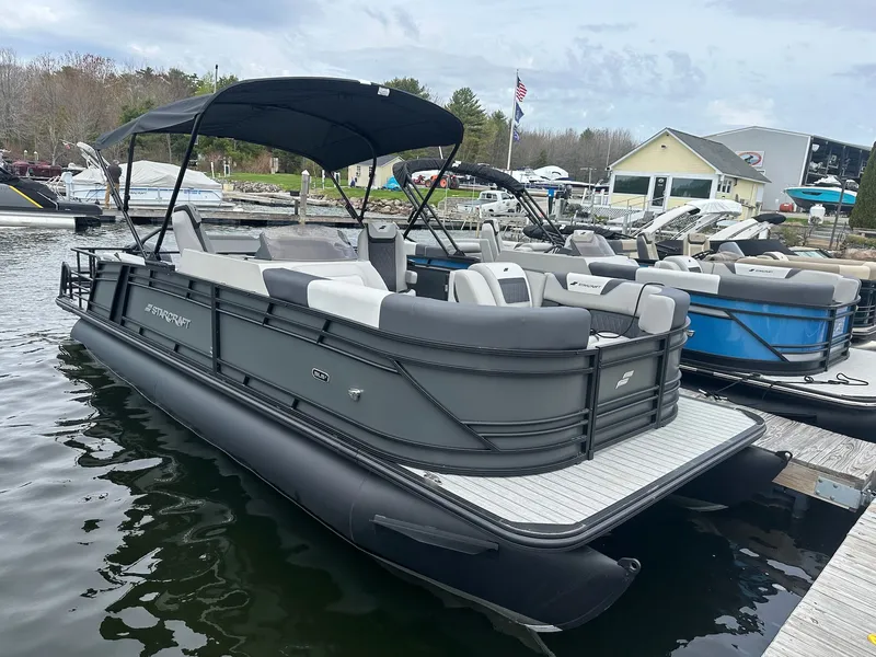 Slide: The Image of 2026 Starcraft SLS 3 R pontoon boat docked at marina. - 2