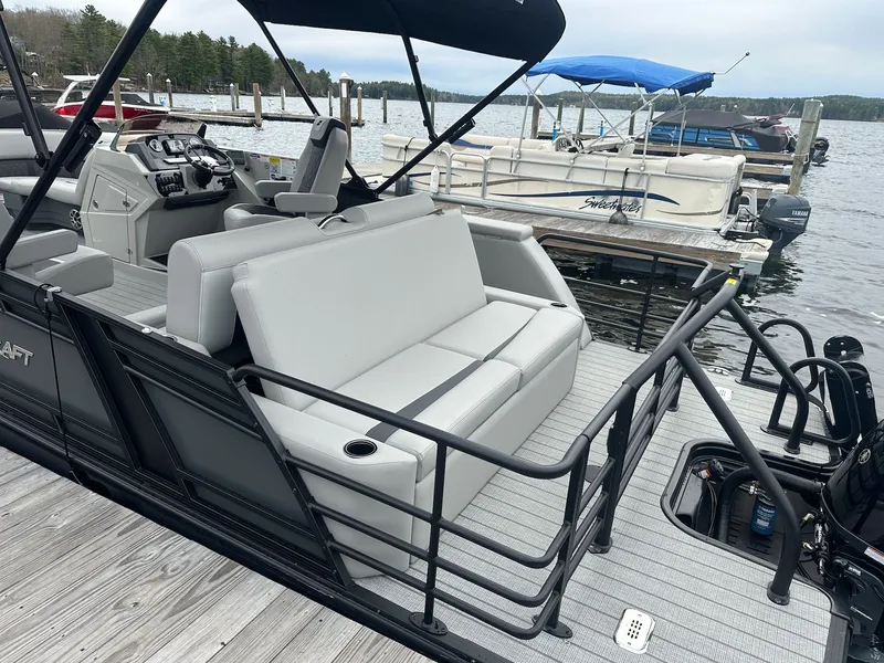 Slide: The Image of 2026 Starcraft SLS 3 R pontoon boat docked with gray seating. - 7