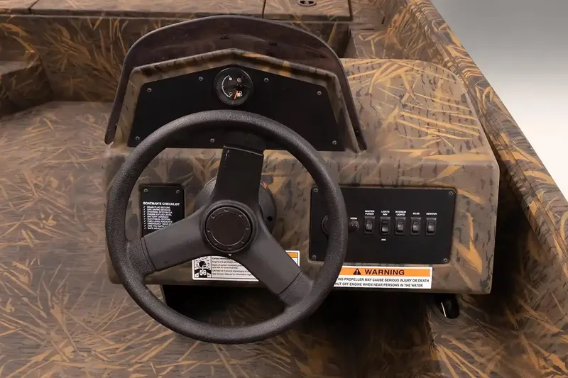 Slide: The Image of 2026 G3 Gator Tough 20 SC boat interior with camo design and steering console. - 4